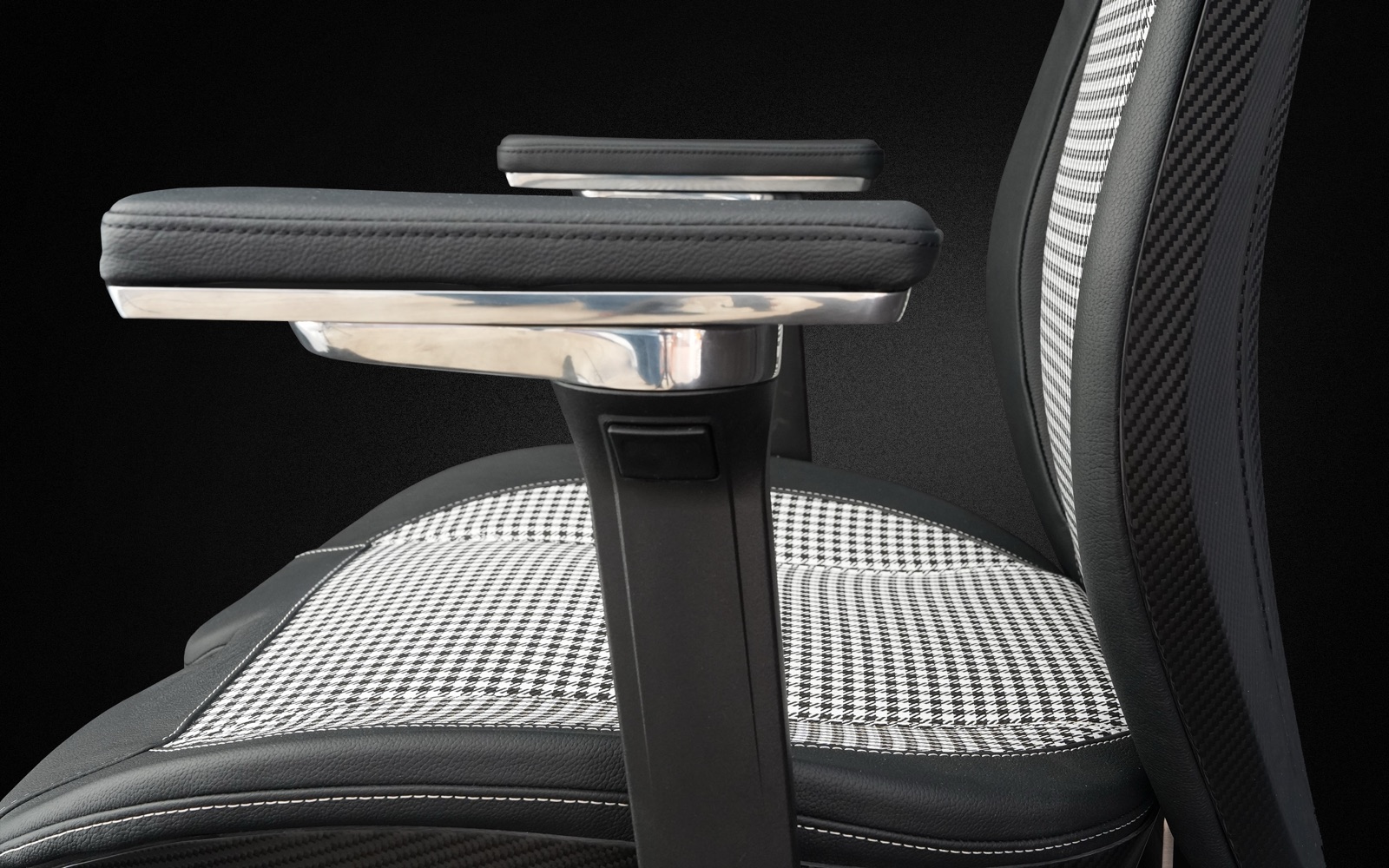 Armrest detail with polished aluminium and houndstooth seat